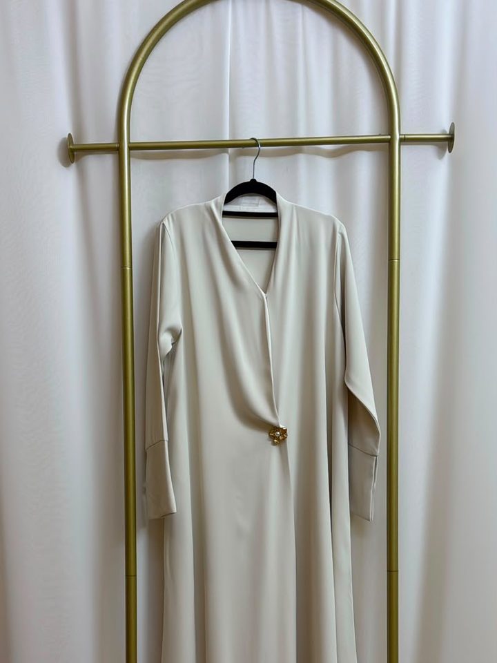 Ivory abaya on a gold rail